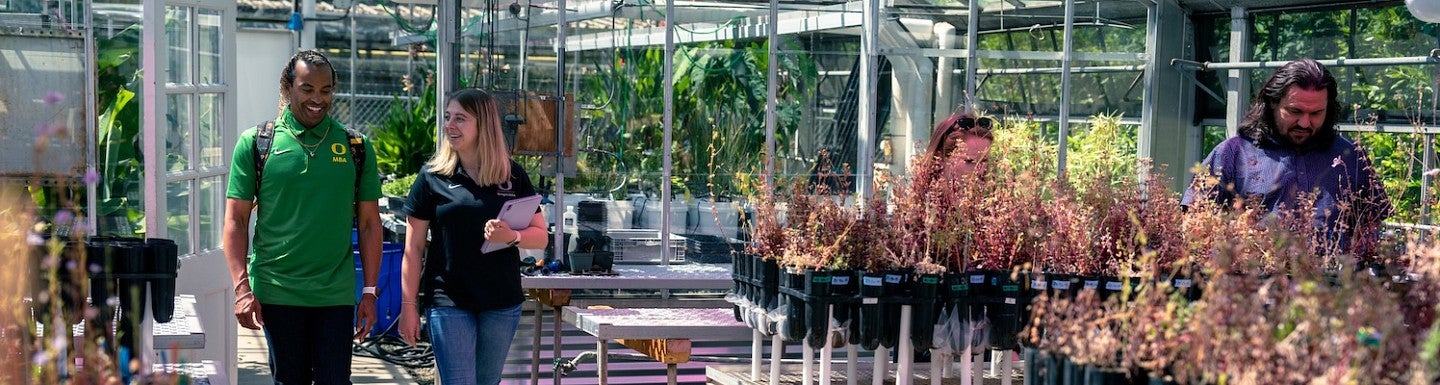 Sustainable Business Practices MBA students in a greenhouse facility.